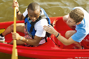 Two students paddling a canoe on a UBalt trip