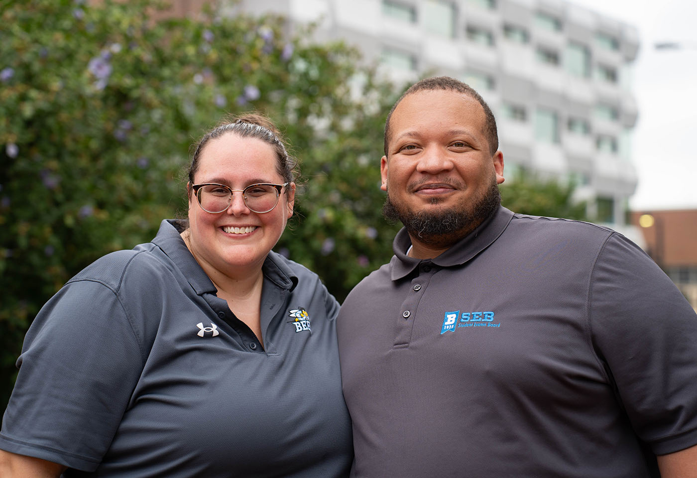 Two people smile for a photo.